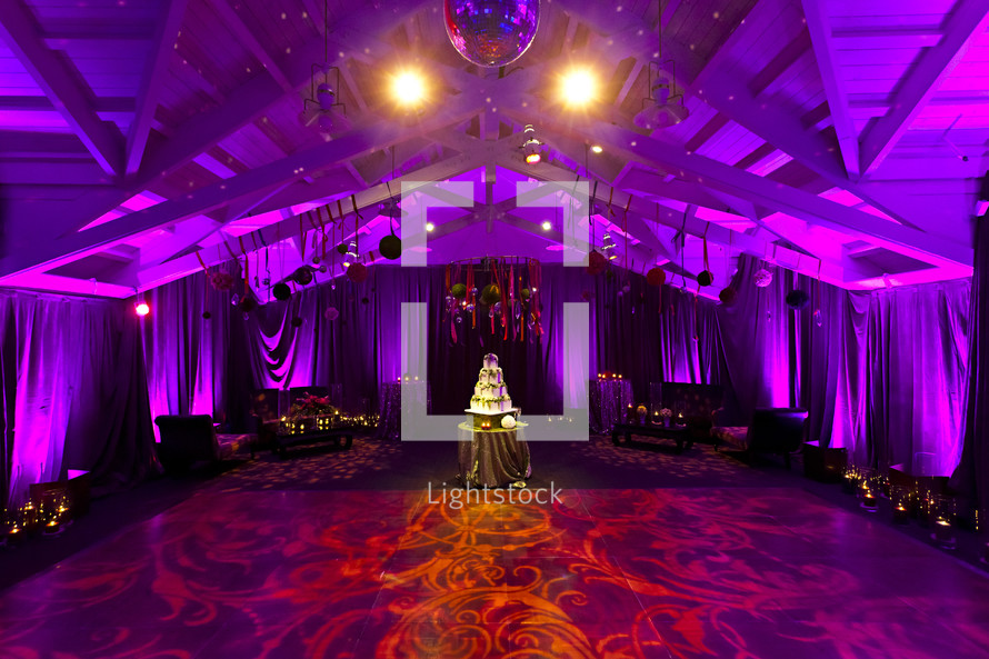 A wedding reception room dancing cake celebration event lighting