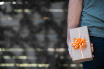 a man holding a wrapped gift 