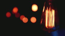 glowing Edison bulbs in darkness 