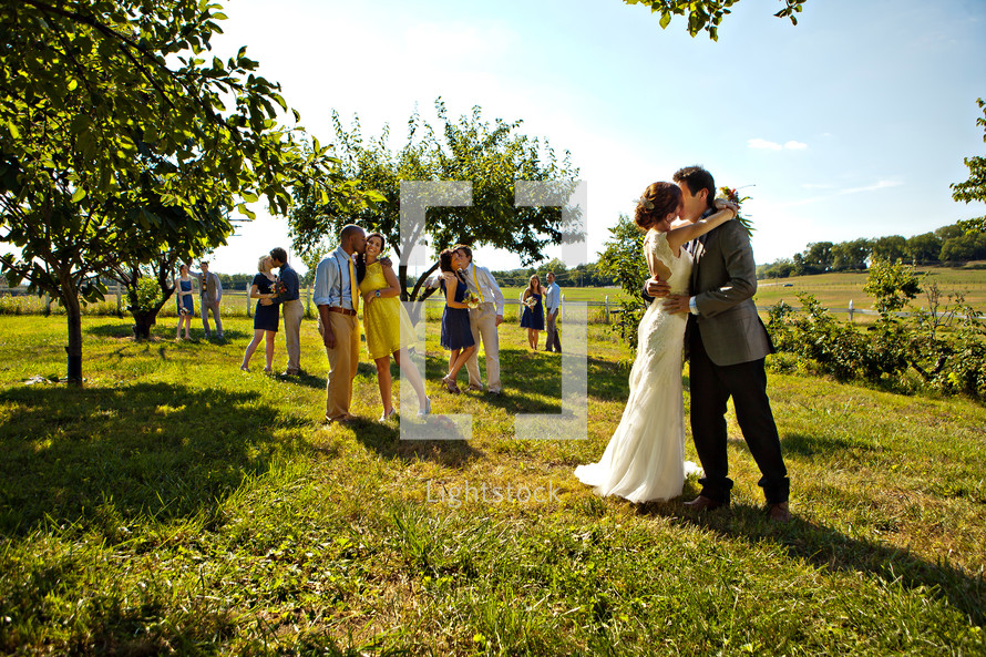 bride and groom and couples kissing