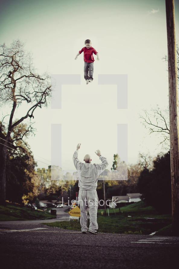 Father throwing son in air