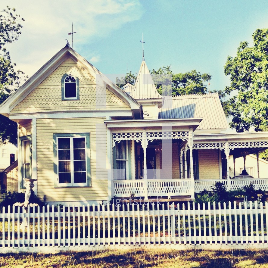 Yellow house and white picket fence