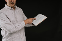 man reading from a Bible