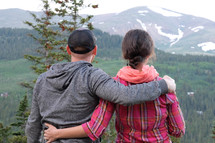 a couple in front of a mountain view 