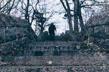 a man walking up stone steps outdoors 