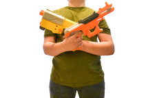 a boy child holding nerf guns 