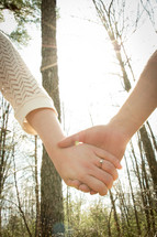 a couple holding hands outdoors 