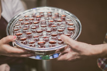 passing a tray of communion cups 