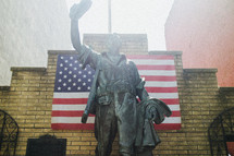 Statue and an American flag