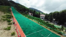 Green synthetic ski slope in the mountain 