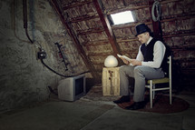 a man reading in an attic 