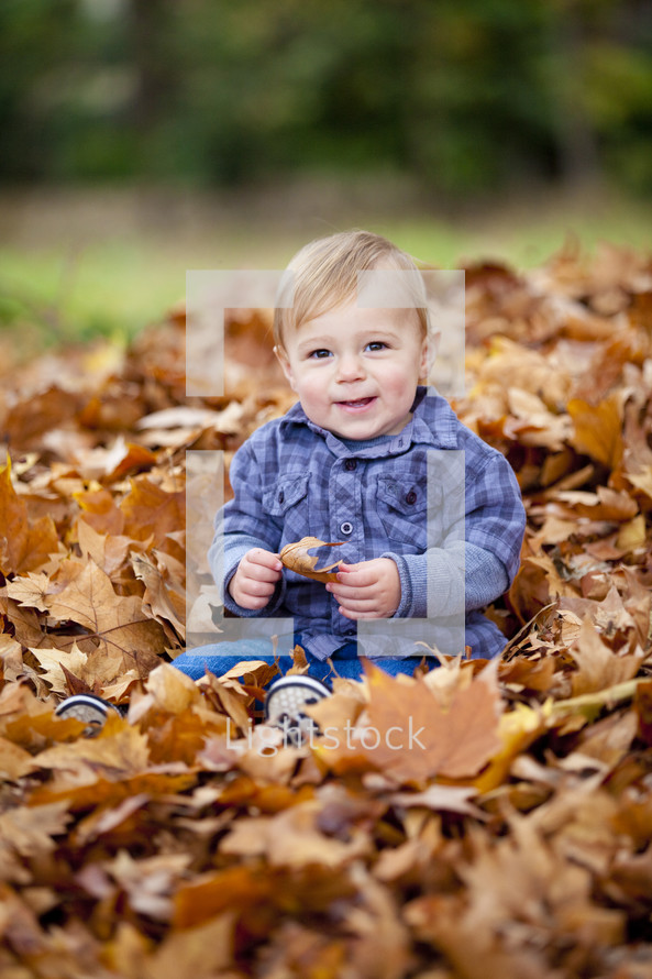Toddler playing in the leaves