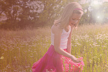 girl child picking wild flowers