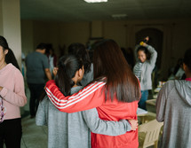 young women hugging after church 