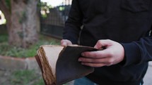 Boy Opens Ancient Book Outside