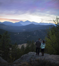 couple standing on a mountaintop 