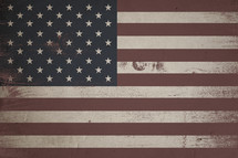 American flag painted on wood background.