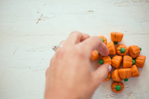 hand reaching for pumpkin candies 