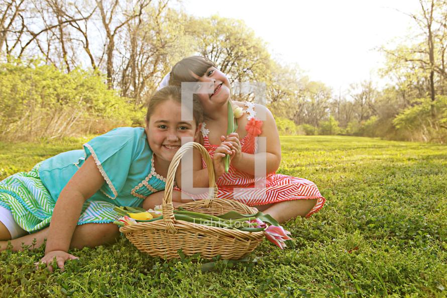 Girl sitting in a field with basket