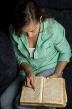 Woman reading old word Bible