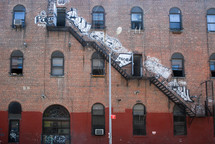 grafitti and fire escape on a brick building in New York City 