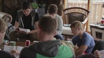 young men and women reading a Bible at a Bible study 