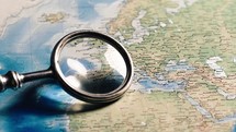 Magnifying glass on world map