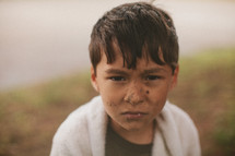 A young boy with a dirty face