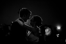 Silhouette of bride and groom dancing