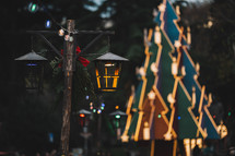 Vintage street lamps with a Christmas tree in the background