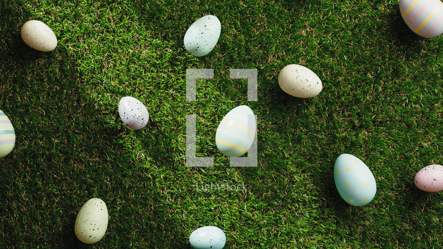 Decorated Easter eggs on a green grass background