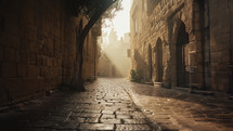 A low-angle shot of an empty street in Jerusalem in the early morning. Sunlight eliminated the street and lights up the cobblestones. 