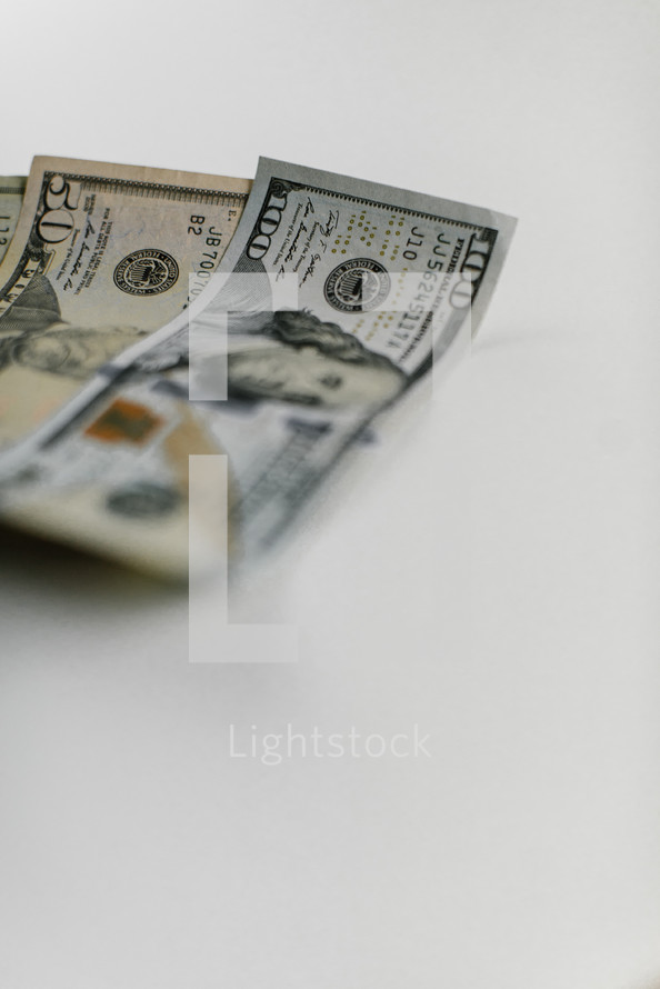Various denominations of bills on a white background.