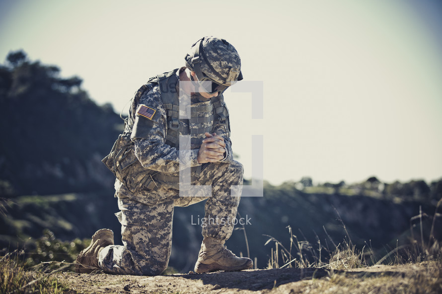 soldier kneeling in prayer