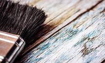 paint brush on weathered wood background 