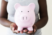 woman holding a piggy bank