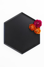 flowers on a black tray 
