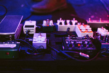 a man with his foot on a guitar pedal 