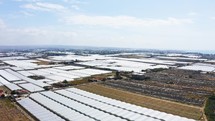 Expanses of fields with greenhouses