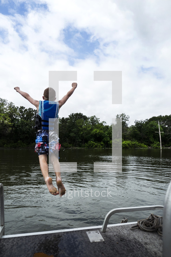 child jumping into a lake 