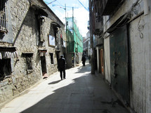 man in an alley in Tibet