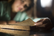 teen girl reading from a Bible