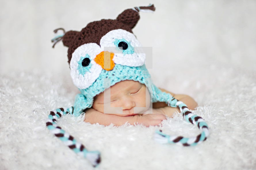 Sleeping infant with owl hat