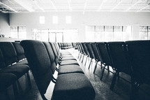 rows of empty chairs in a church