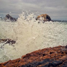 Ocean waves crashing against rock.