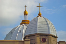 Golden crosses on top of domes on a church
