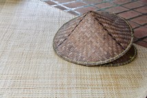straw hats on a straw mat background traditional eastern oriental