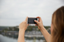 a woman taking a picture with a smartphone 