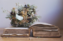 a bouquet of dried flowers on an old book 