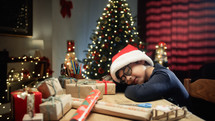 little boy yawning and falling asleep on his desk in Christmas